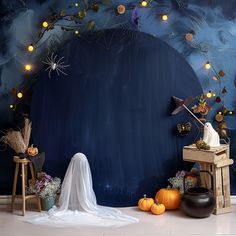 a halloween scene with pumpkins, ghost and other decorations in front of a dark blue background