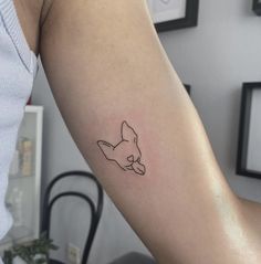 a small tattoo on the arm of a woman