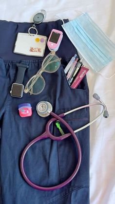 an assortment of medical items laid out on top of a white bed with blue sheets