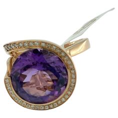 This IGI Certified Cocktail Ring is a true showstopper, exuding elegance and sophistication with its captivating design. Crafted from luxurious 18kt rose gold, it boasts a warm and romantic hue that complements the beauty of its gemstones. At the heart of the ring dazzles a stunning 13.00ct amethyst, radiating with a rich and vibrant purple hue. The amethyst serves as the focal point of the piece, drawing attention with its mesmerizing color and impressive size. Surrounding the amethyst are 40 s Bypass Ring, Vibrant Purple, Diamond Cocktail Rings, Ring Rose Gold, Purple Hues, Gold Set, Sparkle Diamonds, Cocktail Ring, Cocktail Rings