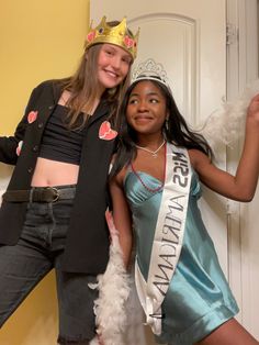 two women in costumes posing for the camera with one woman wearing a tiara on her head