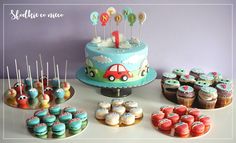 a table topped with lots of cupcakes and cakes