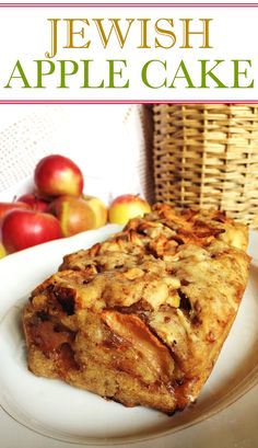 a close up of a slice of cake on a plate with apples in the background