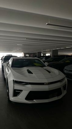 several cars are parked in a parking garage