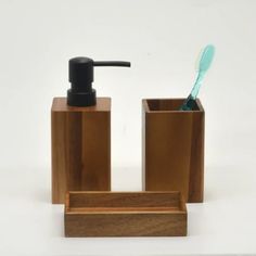 a toothbrush and soap dispenser in wooden containers