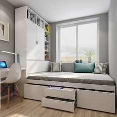 a room with a bed, desk and drawers in it's center area next to a window