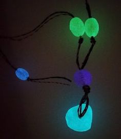 glow in the dark necklace with three glowing balls on it's end and cord