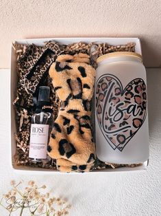 an open box containing a bottle, scarf, and hand towel with the word boss written on it