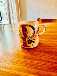 a coffee cup sitting on top of a wooden table