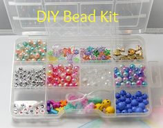 a plastic container filled with lots of different colored beads and bead kits on top of a table