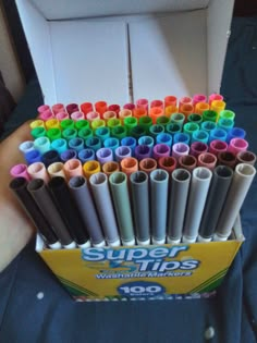 a box filled with lots of different colored crayons in it's wrappers