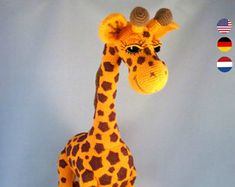 a stuffed giraffe is posed in front of a blue background