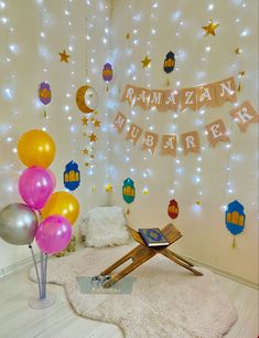 the room is decorated with balloons, stars and garlands that spell out baby's name