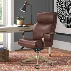 a brown leather office chair sitting on top of a rug