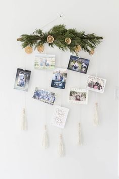 a white wall with pictures hanging from it and christmas decorations on the wall next to it