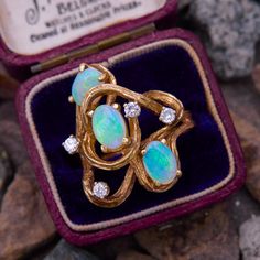 This vintage swirling ring features three oval cabochon semi-crystal Australian opals accented with gold texturing and four bright diamonds.  The ring is crafted in 14k yellow gold and is currently a size 6. Vintage Opal Ring, Opal Ring Vintage, Opal Diamond Ring, Princess Ring, Swirl Ring, Opal Ring, Australian Opal, Opal Crystal, Gold Texture