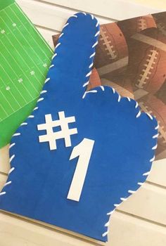 a paper cut out of the shape of a number 1 with footballs in the background