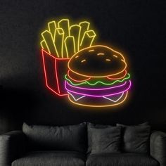 a neon sign that is on the wall next to a couch