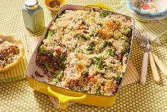 a casserole dish with broccoli and rice in it on a table