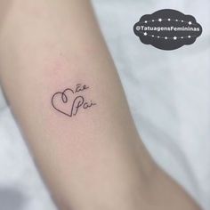 a small tattoo with the word love written in cursive writing on the arm