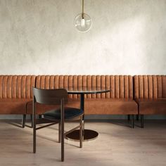 a table with two chairs and a bench in front of a wall that has a light bulb hanging above it