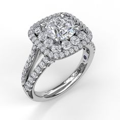 a diamond engagement ring with two rows of diamonds around it