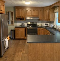 a kitchen with wooden cabinets and stainless steel appliances