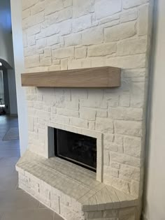 a white brick fireplace with shelves above it