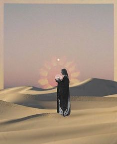 a woman standing in the middle of a desert