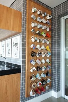 a wall mounted tea cups and saucers in a kitchen