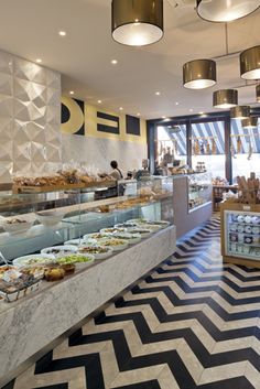 a restaurant with many different types of food on display in the front counter and side by side buffets