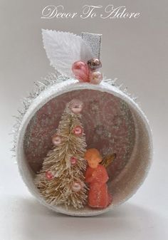 an ornament with a small christmas tree inside