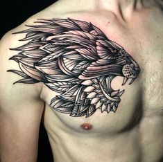 a man's chest with an intricate tattoo design on his chest and the head of a lion