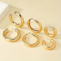 This Set Of Three Chunky Hoop Earrings Offers A Versatile Selection Of Bold, Stylish Accessories In Varying Sizes. Each Pair Features A Thick, Rounded Design, Giving Them A Striking, Statement-Making Appearance While Maintaining A Classic Hoop Shape. Crafted With A Smooth, Polished Finishwhether In Gold, Silver, Or Another Metallic Tonethese Hoops Add A Modern Touch To Any Outfit. Their Lightweight Construction Ensures Comfort Without Compromising On Their Bold Look. Perfect For Elevating Both C Chunky Hoop Earrings, Round Design, Stylish Accessories, Jewelry Set, Timeless Elegance, Jewelry Earrings, Hoop Earrings, Women Jewelry, Silver