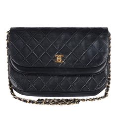 Authentic Chanel classic double flap shoulder bag in black quilted calfskin leather. Features black quilted calfskin leather and a gorgeous chain strap with 24kt gold plated hardware. Its CC turn-lock closure opens to a double flap-lined interior with a zipper slip pocket. This Chanel bag is the perfect size for all your essentials. You're going to love it! Strap drop: 15" Made in France 1994-1996 This bag has the 24 kt gold plated hardware. The interior was relined by Chanel, no hologram stamp Formal Quilted Double Flap Bag, Classic Quilted Flap Bag For Evening, Timeless Quilted Shoulder Bag For Formal Occasions, Classic Quilted Evening Flap Bag, Elegant Quilted Flap Bag For Evening, Elegant Quilted Flap Bag For Business, Chanel Double Flap, Flap Shoulder Bag, Quilted Pattern