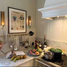 the kitchen counter is covered with various types of cooking utensils and cookbooks