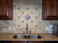 a kitchen sink with wooden cabinets and tile backsplash in the backround