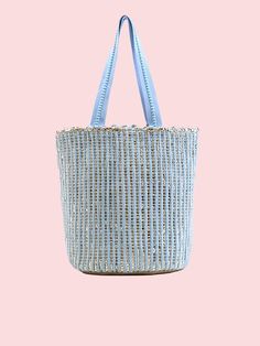 Feeling blue never looked so good! America & Beyond - Natural Beauty Upcycled Hand-Woven Light Blue Tote is here to add a splash of eco-friendly fun to your life. This multi-purpose tote, crafted from hand-weaving fabric with a lurex, is perfect for any adventure. With double shoulder straps adorned with lace details and a playful pom pom tassel charm, it's super stylish & so easy to carry. Inside, you'll find a hanging zip pocket for your essentials and a magnetic button closure to keep everyth Blue Bucket Bag For Spring, Eco-friendly Blue Handwoven Beach Bag, Blue Rectangular Bucket Bag For Spring, Blue Bucket Bag For Daily Use In Spring, Eco-friendly Handwoven Blue Beach Bag, Blue Handwoven Summer Beach Bag, Eco-friendly Blue Beach Bag, Casual Blue Woven Straw Bag, Blue Spring Bucket Bag