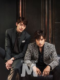 two young men sitting next to each other wearing suits and ties, posing for the camera