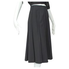 In seasonless wool gabardine, this wardrobe workhorse features a universally-flattering flared trumpet silhouette and ten ridged gores for an exceptional 7.5 foot swing. Literally a wear-with-anything staple you will never tire of. Swirling trumpet skirt with ten seamed gores around full circumference of skirt; no waistband. Minuscule left side zipper closure with two hooks and tabs inside waistband; fully lined in black viscose. fabric: wool gabardine, viscose noteworthy: dry clean only alterat Trumpet Silhouette, Trumpet Skirt, Fabric Wool, Viscose Fabric, Flare Skirt, Side Zipper, What To Wear, High Waisted Skirt, Midi Skirt