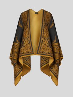 Wool-blend cape featuring a placed floral paisley print with ornamental trim on the hem.• Made in Italy • 85% wool, 15% modal Cape Designs, Italian Textiles, Poncho Jacket, Last Unicorn, Wool Cape, African Inspired Fashion, Suit Shirts, Handkerchief Hem, Fragrance Collection