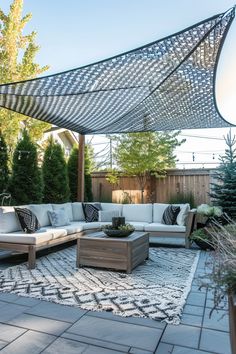 an outdoor living area with couches and tables