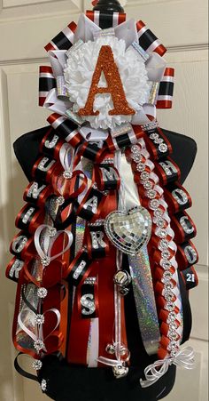 a christmas tree made out of ribbons and other items is displayed in front of a door