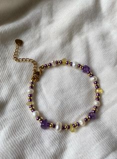 ✨ Elegant beaded bracelet perfect for everyday wear and layering - treat yourself or your loved one! ✨ Every piece is made using stainless steel clasp and extension chain.  🤍Size: - 16cm / 6.5 inches plus extension chain 🤍Materials: - Freshwater pearls - Amethysts - Citrines  - 18k gold plated beads - Purple beads  🤍Care info: - Selune Pearls jewelry is safe to wear every day. Please note that it is recommended that frequent contact with water, perfume and hard chemicals is avoided where poss