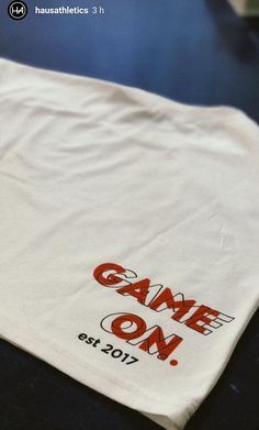 a white t - shirt with game on printed on it