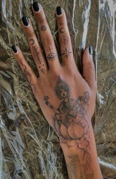 a woman's hand with tattoos on it