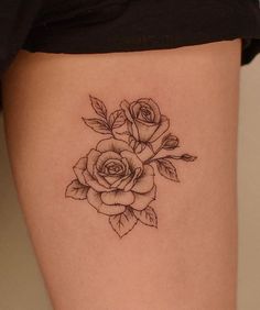 a woman's thigh with a rose tattoo on it