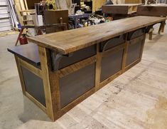 a large wooden table sitting inside of a shop