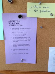 a bulletin board with sticky notes attached to it