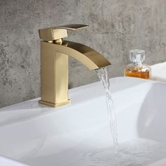 a faucet with water running from it's spout in a bathroom